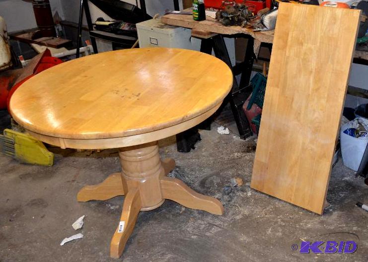 lot 40 image: Wood table 36" diameter with extra leaf ...