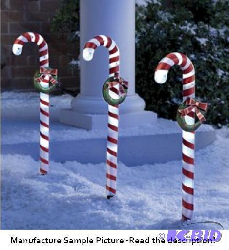 lot 14 image: Three Piece Candy Cane Solar Stake Set - A sw...