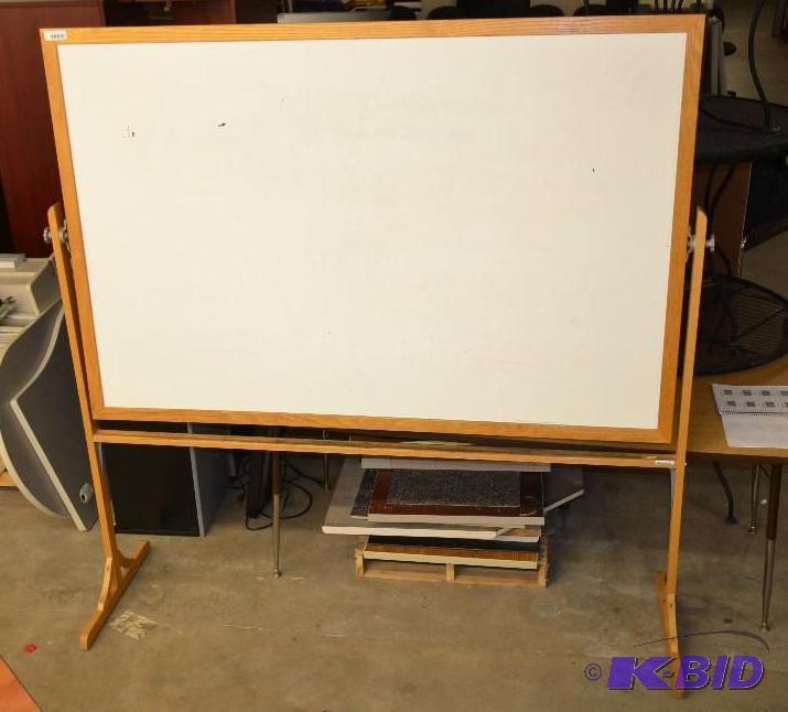 lot 77 image: White board, rotates, two sided, oak wood fra...