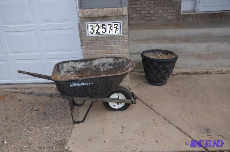 lot 153 image: 6 cubic feet wheel barrow and one large pot 2...
