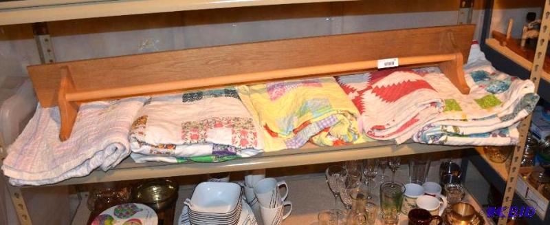 lot 104 image: Wood quilt rack 57" long with 5 quilts...