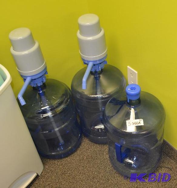 lot 193 image: 5 gallon water jugs , two have pumps...