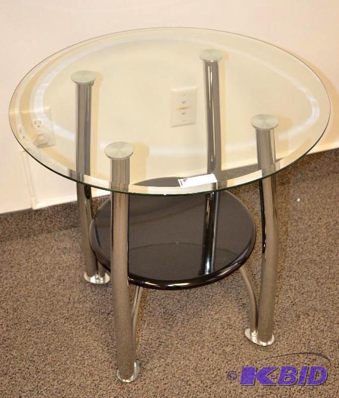 lot 1F image: Circular glass table with metal legs and seco...