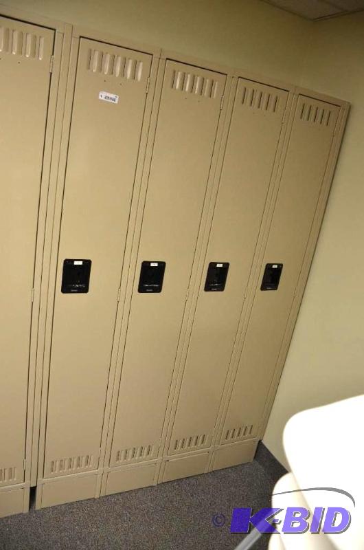 lot 94 image: Four tan lockers. Each one has a lock but loc...