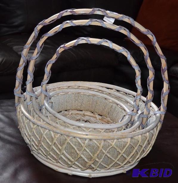 Three nested decorative baskets the largest i...