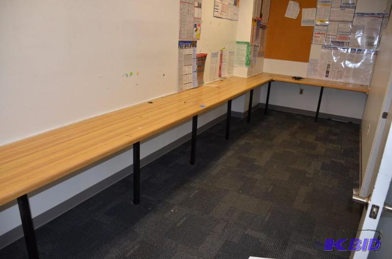 lot 56 image: Long L shaped classroom workstations with cho...