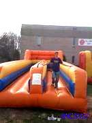 lot 19 image: Inflatable bungee run, vests not included bu...