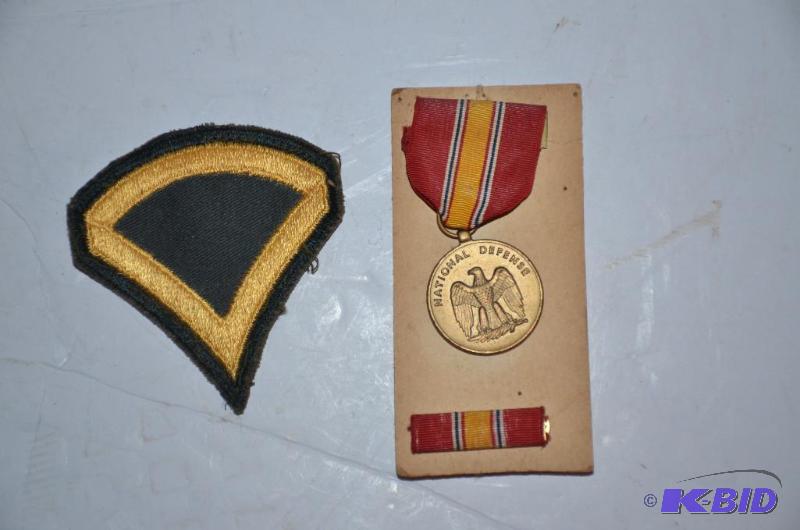 lot 147 image: National defense medal and badge...