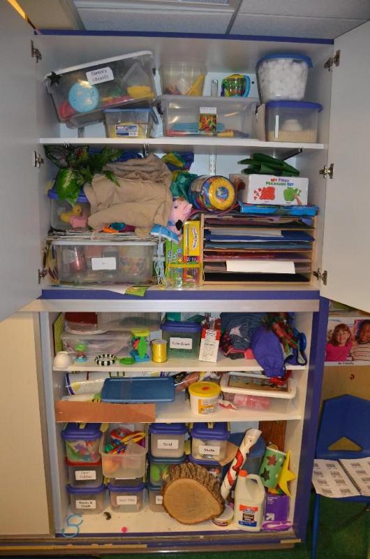 lot 109 image: Contents of cabinet - sensory toys, peg board...