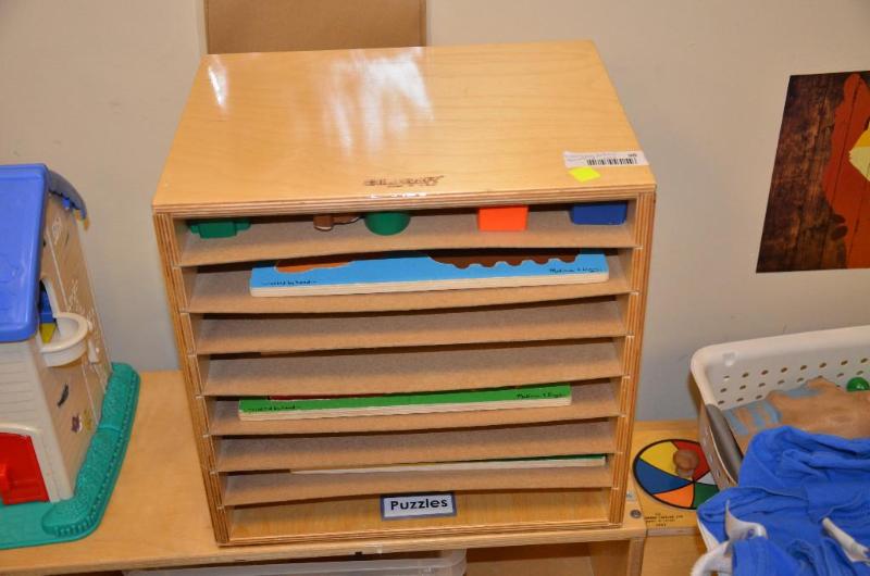 lot 98 image: Childcraft puzzle rack with wood puzzles. 15x...