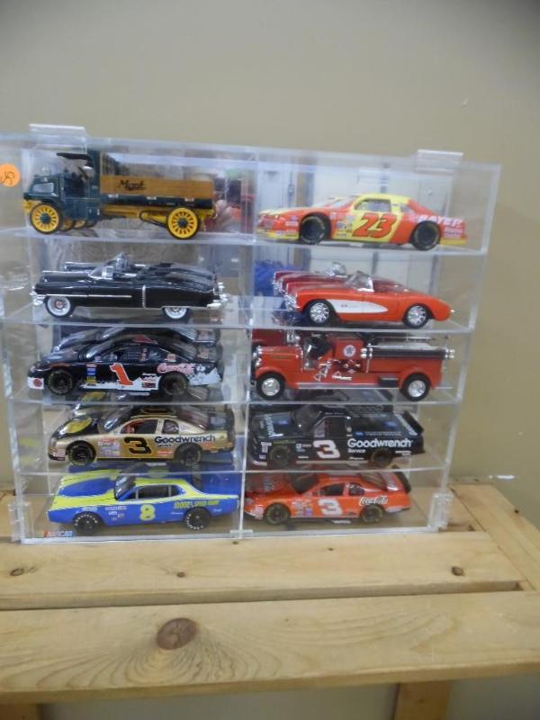lot 55 image: Die-cast cars in display cabinet