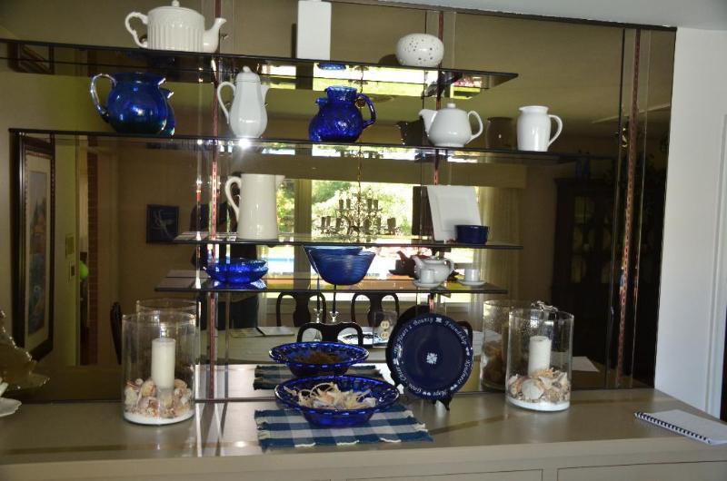 White china on shelves &amp sea shells in la...