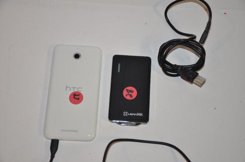 lot 27 image: HTC cell phone white with power cord, powers ...