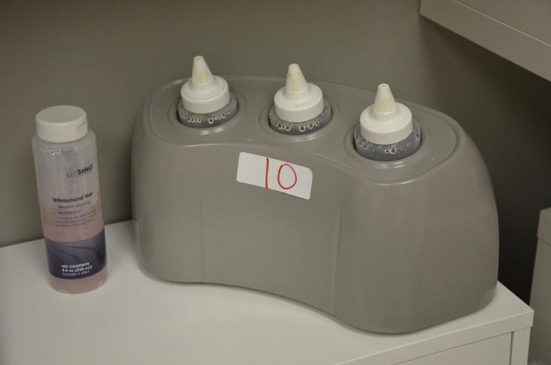 lot 10 image: Rich-Mar Gel and Lotion Warmer with 4 bottles...
