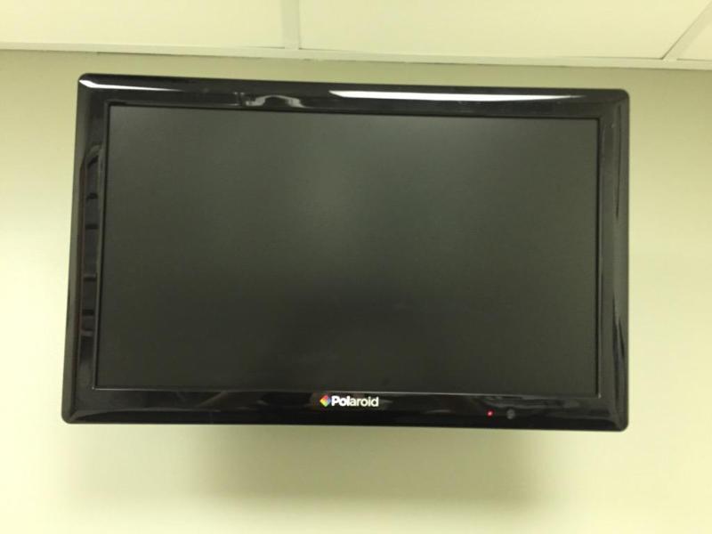 lot 14 image: 21" Polaroid TV with wall mount & re...