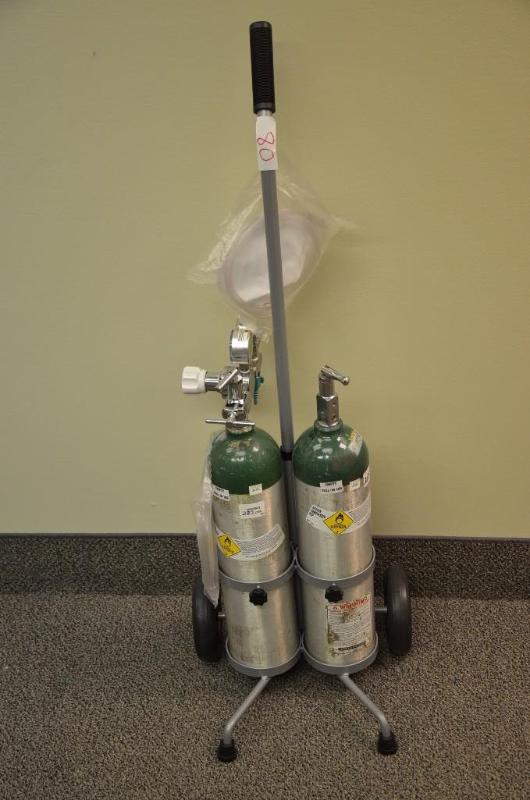 lot 80 image: 2 oxygen tanks(with gages) and one rolling st...