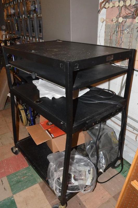 lot 112 image: Mobile Tv stand with power strip. Contents no...