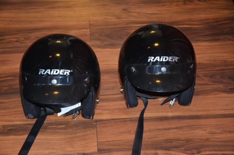 Two motorcycle helmets, Raiders size large an...