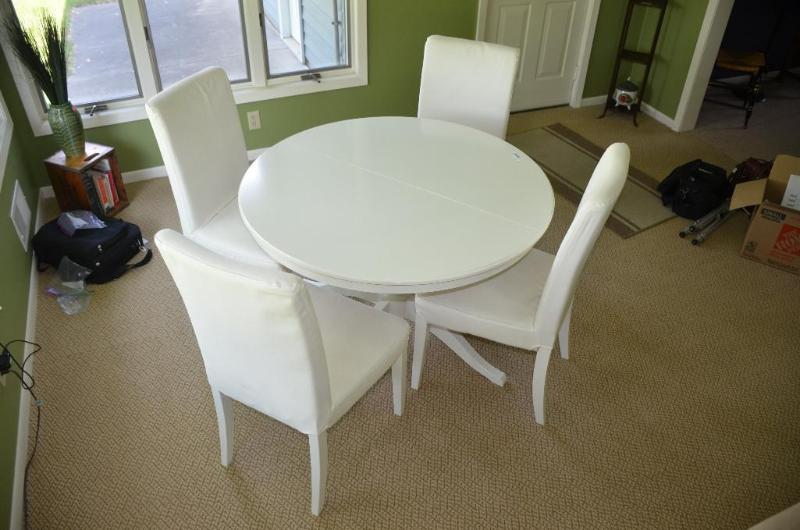 lot 129 image: White wood table 42" diameter and 4 chai...