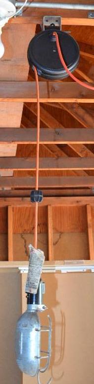 lot 123 image: Retractible light  extension cord. Bring too...
