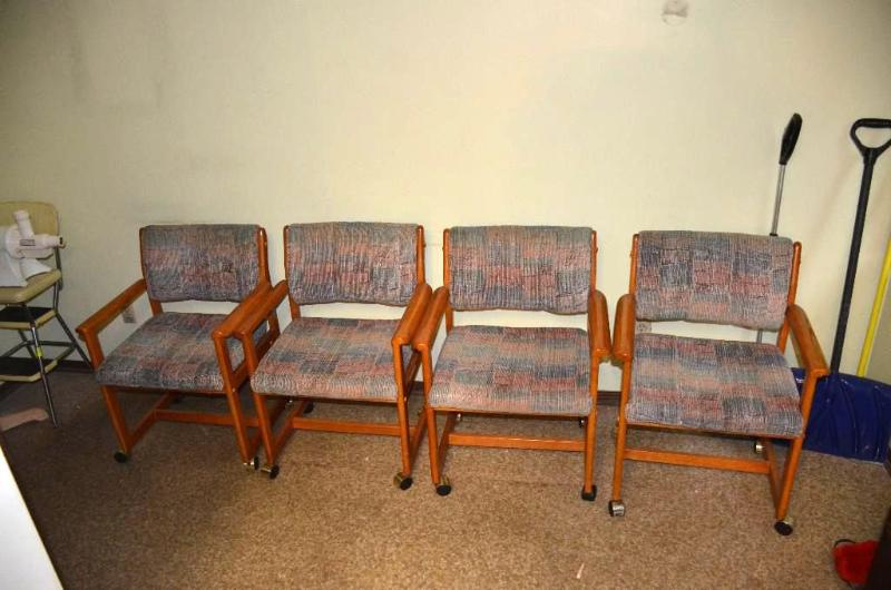 lot 33 image: four wood  chairs on rollers.  ...