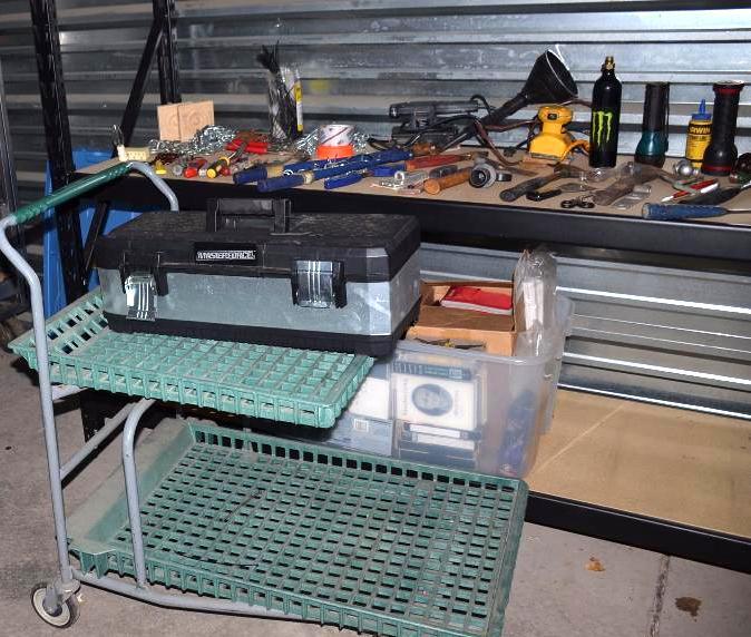 Rolling green tool cart and large group of...