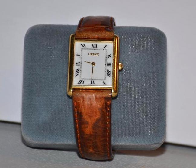 18K Solid Gold Gucci Watch with leather band....