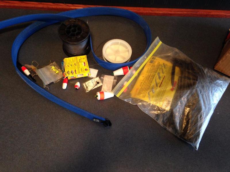 Rod cover, rubber bait worms, fishing line, lures and bobbers