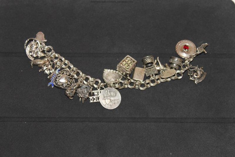 lot 77 image: Many Sterling Silver Charms on Bracelet. ...