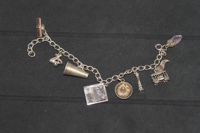 lot 78 image: Many Sterling Silver Charms on Bracelet....