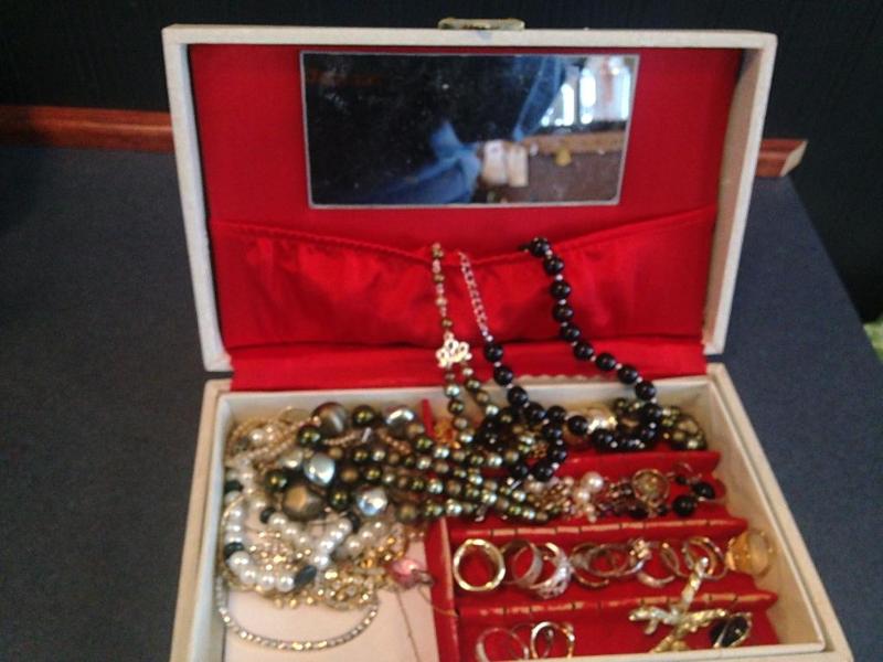 A vintage jewelry box filled with jewelry &n...