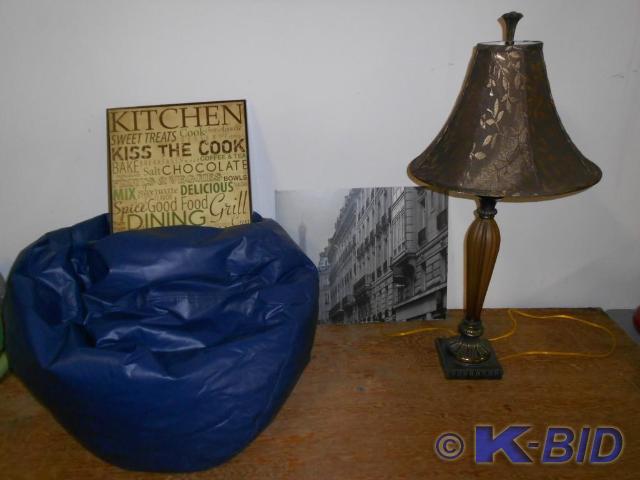 Blue bean bag, lamp and wall art.