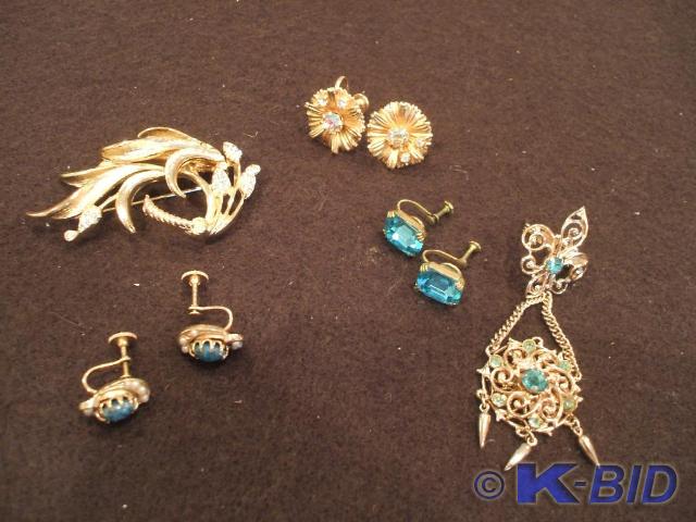 A gold and aquamarine rhinestone pi...
