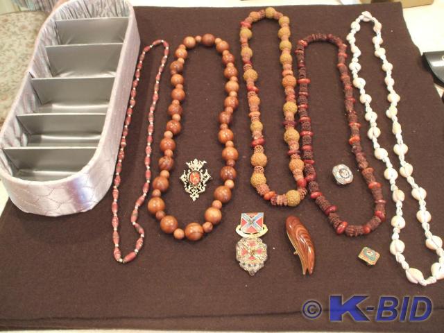 A gray satin glove box, 5 necklaces...