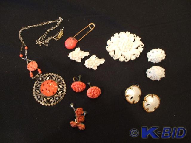 A coral color necklace and 2 pair o...