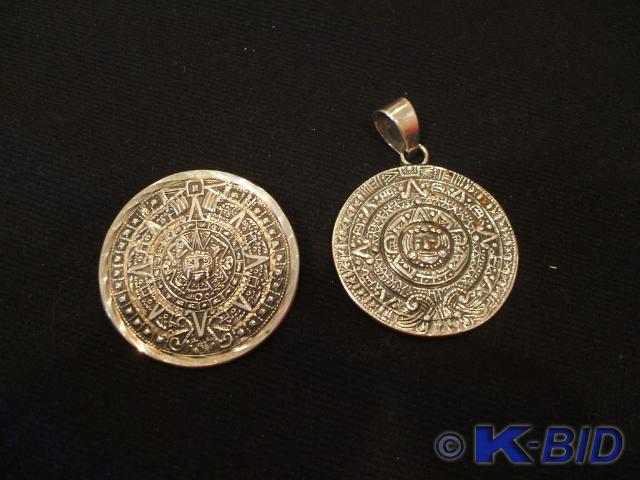 A matching pin and pendant made of ...