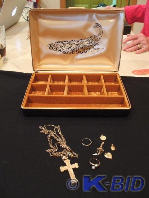 A gold pendant with small pearls at...