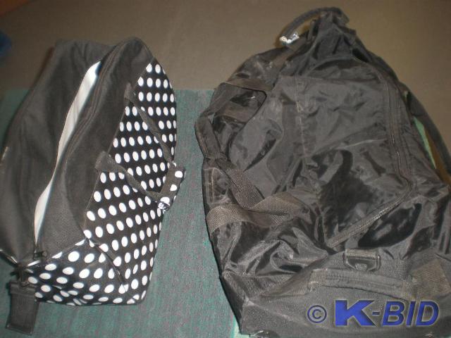 Black travel bag on wheels.  Polka ...