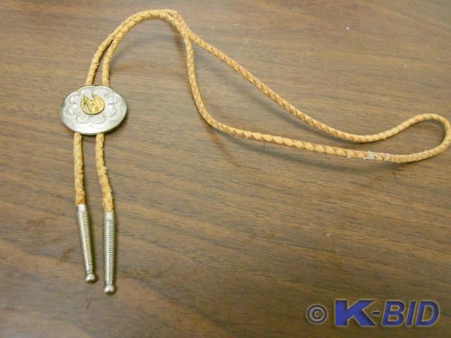 lot 101 image: Light brown tie with silver round p...