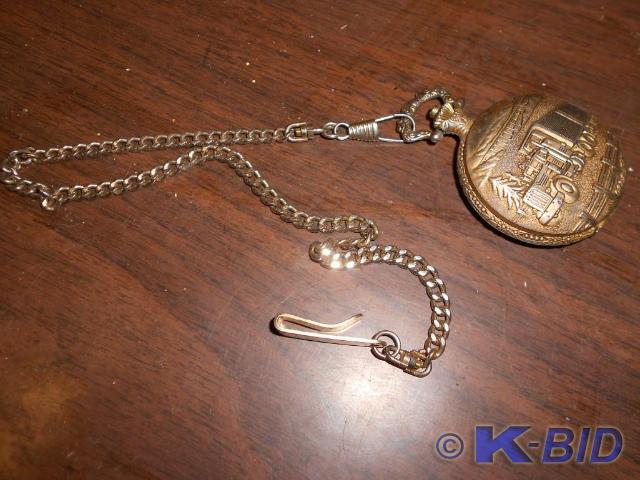 lot 48 image: Antique semi truck golden Stopwatch...