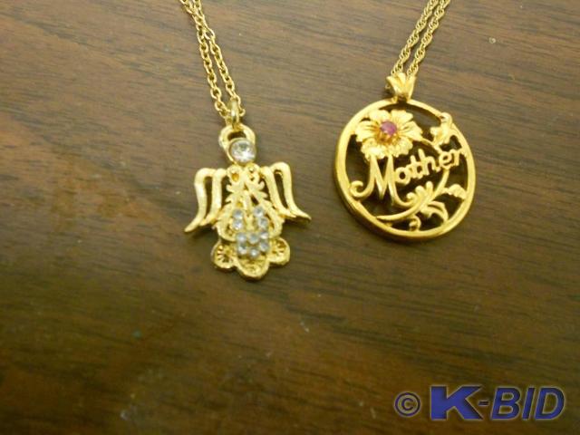 lot 79 image: Gold chained necklace with charm sa...