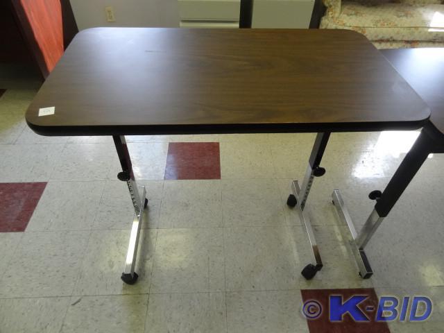 lot 15 image: Adjustable height table on wheels. ...