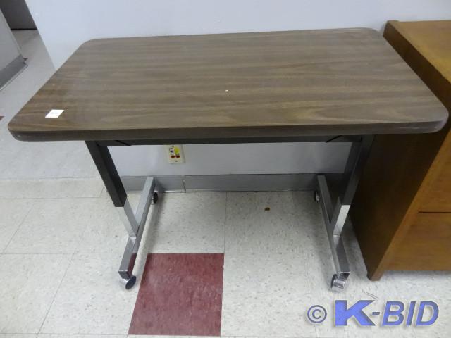 lot 44 image: Adjustable height table on wheels. ...
