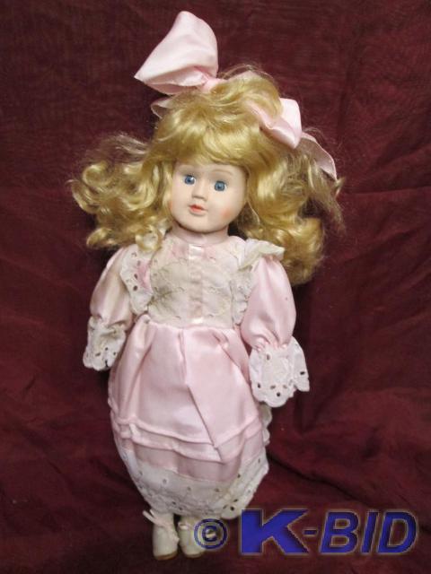 lot 185 image: Pretty porcelain doll in a satin pi...