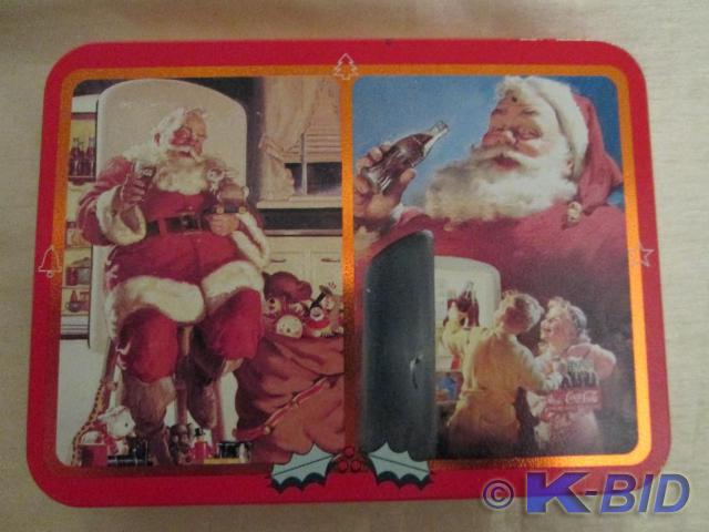 lot 44 image: Coca-Cola Christmas tin with two de...