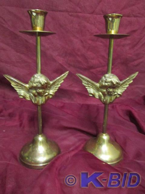 lot 49 image: Solid brass cherub candle sticks.