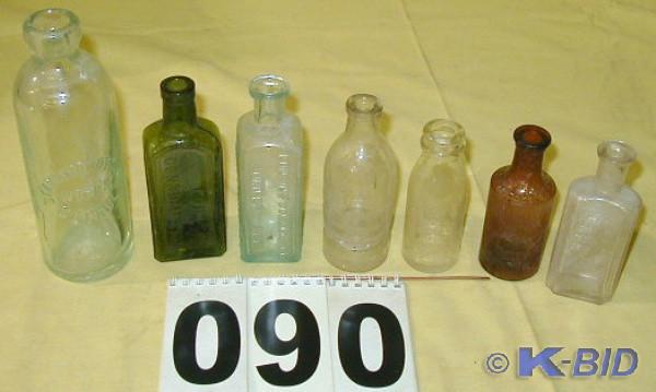 lot 90 image: Seven Vintage Embossed Glass Bottle...