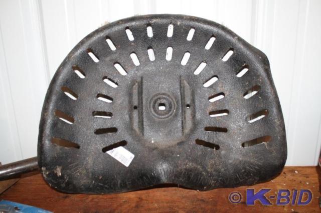 lot 322 image: Antique metal farm tractor seat. No...