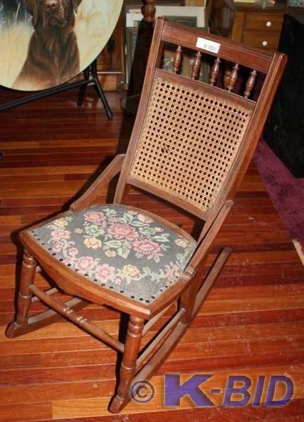 lot 63 image: Vintage wood rocker with cane back